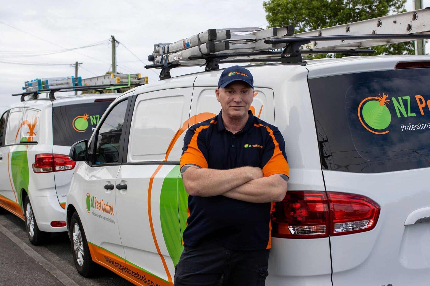 Stuart, owner of NZ Pest Control, with the company vans